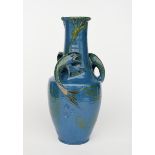 A tall C H Brannam pottery vase, shouldered form with tapering neck and everted rim, modelled in