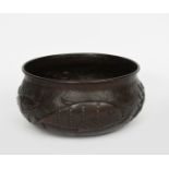 A repousse hammered patinated copper bowl by John Pearson, dated 1899, shouldered, circular form,