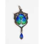 A James Fenton silver and enamel pendant, elaborate shield shape, cast in low relief with foliate