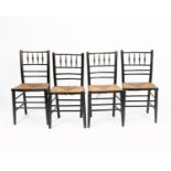 A set of four Morris and Co Sussex ebonised wood chairs, each turned wood frame with rush seat and