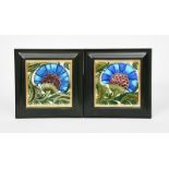 A pair of William De Morgan BBB tiles, each painted in shades of blue, aubergine and green on a