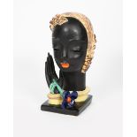 A Goldscheider Pottery bust of a woman, freestanding bust, her hand raised and releasing a blue