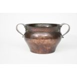 A large Birmingham Guild of Handicraft patinated copper twin-handled jardiniere, the shouldered,