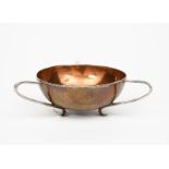 An Arts and Crafts Connell patinated copper and silver bowl, the hammered copper bowl with three