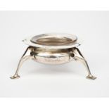 An Arts and Crafts Connell silver salt with glass liner, on tripod feet, the everted rim with