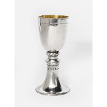 An Artificers' Guild Ltd silver-gilt chalice probably designed by Edward Spencer, tapering foot
