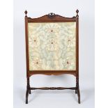 A Morris & Co carved mahogany cheval screen, rectangular with carved flower stem panel and ball