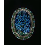 A silver and enamel brooch by George Hunt, dated 1925, the oval frame with central forget me not