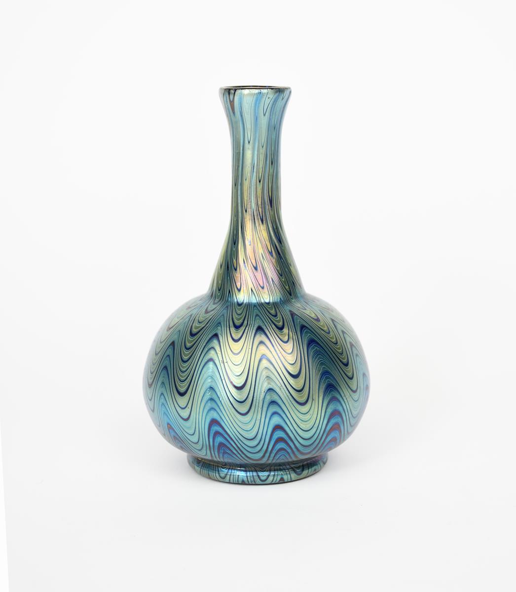 A Loetz glass vase, ovoid with waisted cylindrical neck, covered in a combed iridescence,