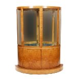 A walnut veneer bow-fronted display cabinet, the curved, hinged doors with curved glass etched