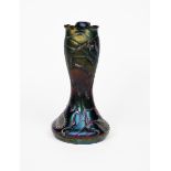 A Palme Koenig iridescent glass vase, compressed ovoid body with tall swollen neck, cast in low