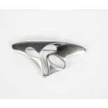 A Georg Jensen silver brooch designed by Henning Koppel, model no.325, cast and pierced abstract