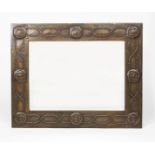A Glasgow School patinated metal wall mirror, rectangular, stamped in low relief with a Glasgow Rose