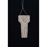 ? An ivory crucifix pendant in the manner of Eric Gill, carved in low relief with Christ on a