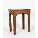 A Liberty & Co oak occasional table, rectangular top over square section legs, shallow arched