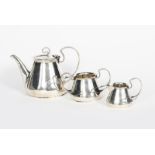 An Art Nouveau George Unite silver three piece tea set, tapering cylindrical form with strapwork