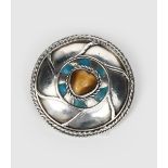 A silver and enamel brooch in the manner of the Artificers' Guild, circular form with rope twist