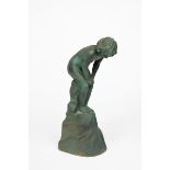 A Doulton stoneware figure of a boy designed by John Broad, modelled crouching and looking down to