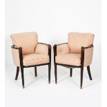 A pair of Hille walnut arm-chairs, tapering legs rising to carved scroll terminal, with pink