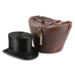 A BLACK SILK TOP HAT EARLY 20TH CENTURY the interior marked with a crowned garter, inscribed '