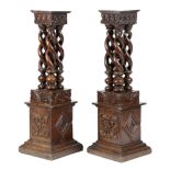 A NEAR PAIR OF OAK SPIRAL TWIST AND CARVED COLUMNS INCORPORATING 17TH CENTURY ELEMENTS decorated