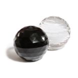 TWO FACETED GLASS BALL PAPERWEIGHTS LATE 19TH CENTURY one clear, the other black, each with a