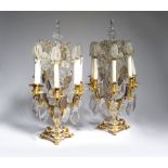 A PAIR OF GILT METAL AND GLASS FIVE-LIGHT CANDELABRA 20TH CENTURY of open scroll form, with a