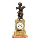 A FRENCH GILT AND PATINATED SPELTER MANTEL CLOCK IN LOUIS XVI STYLE LATE 19TH / EARLY 20TH CENTURY