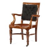 A VICTORIAN WALNUT DESK CHAIR C.1880 with a padded back, scroll arms and a solid saddle seat, on