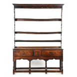 A GEORGE II OAK DRESSER MID-18TH CENTURY the raised plate rack with three shelves, the base fitted