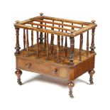 A VICTORIAN WALNUT CANTERBURY C.1860 with three divisions, supported by turned spindles, with a
