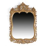A GILTWOOD MIRROR IN 18TH CENTURY STYLE the replaced shaped plate within a leaf, scroll and husk