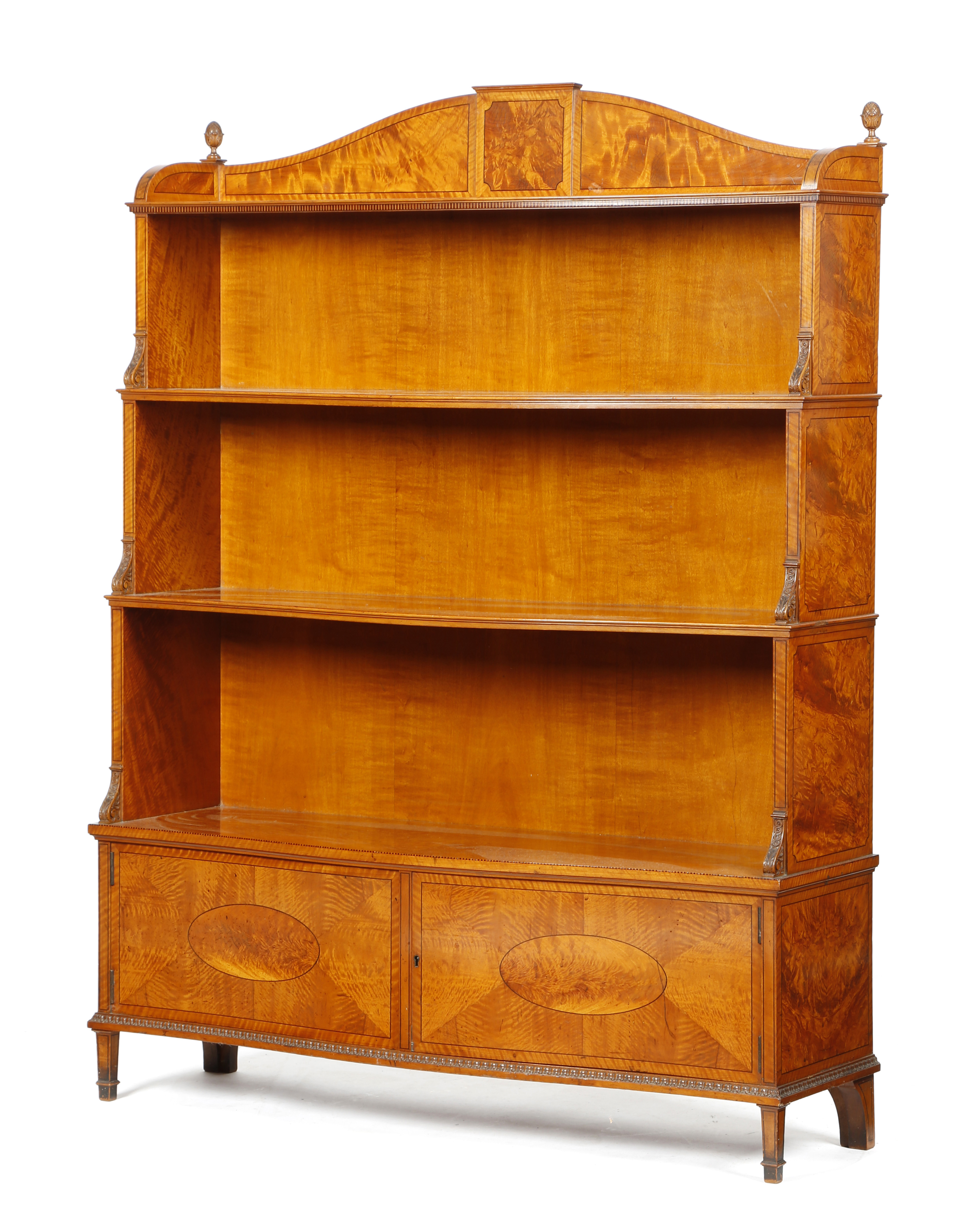 A LATE VICTORIAN SATINWOOD SERPENTINE WATERFALL OPEN BOOKCASE IN THE MANNER OF HOLLAND & SONS OR