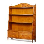 A LATE VICTORIAN SATINWOOD SERPENTINE WATERFALL OPEN BOOKCASE IN THE MANNER OF HOLLAND & SONS OR