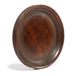 A GEORGE III TREEN MAHOGANY WINE BOTTLE COASTER C.1800-10 of dished form with a moulded edge 15.