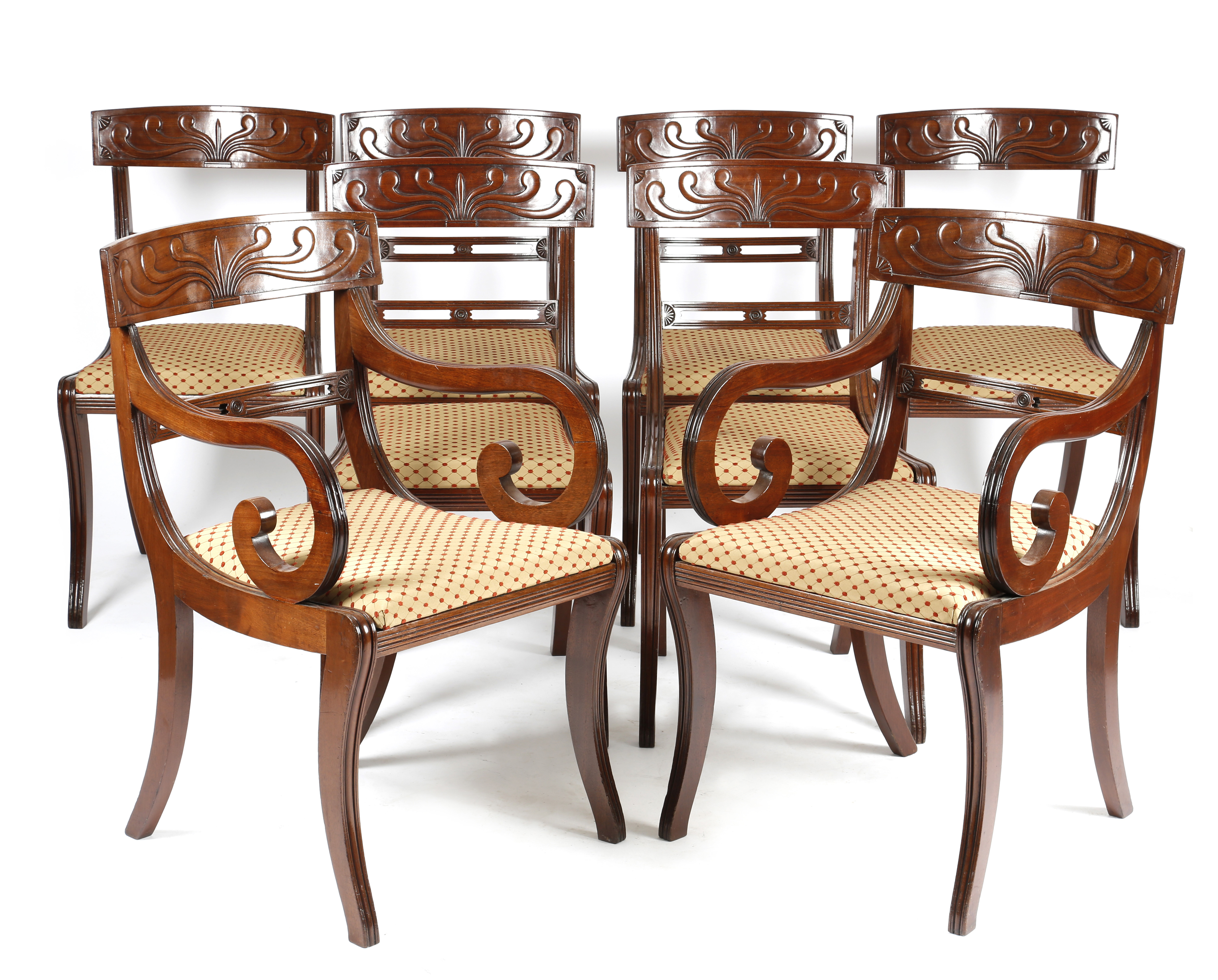 A SET OF EIGHT REGENCY MAHOGANY DINING CHAIRS C.1815-20 each with a palmette and fan carved tablet