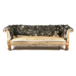 A LATE VICTORIAN CHESTERFIELD SOFA BY GILLOWS C.1880 with scroll arms, on Gothic style oak legs, the