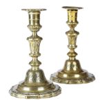 A PAIR OF 18TH CENTURY FRENCH BRASS CANDLESTICKS C.1750-60 of seamed two part construction, with