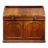 A VICTORIAN MAHOGANY DESK c.1850-60 with a three quarter gallery, above a flame veneered sloping