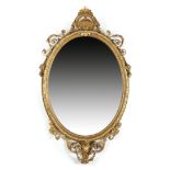 A VICTORIAN GILTWOOD AND GESSO WALL MIRROR C.1860 the oval plate within a beaded inner frame, with a