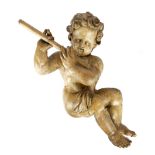 AN ITALIAN BAROQUE CARVED PINE AND LIMEWOOD HANGING CHERUB 17TH / 18TH CENTURY playing a flute, with