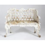 A WHITE PAINTED CAST IRON GARDEN BENCH AFTER A DESIGN BY THE CARRON FOUNDRY, LATE 19TH / EARLY