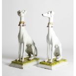 A PAIR OF ITALIAN TIN GLAZED POTTERY MODELS OF WHIPPETS 20TH CENTURY each sporting a tasseled