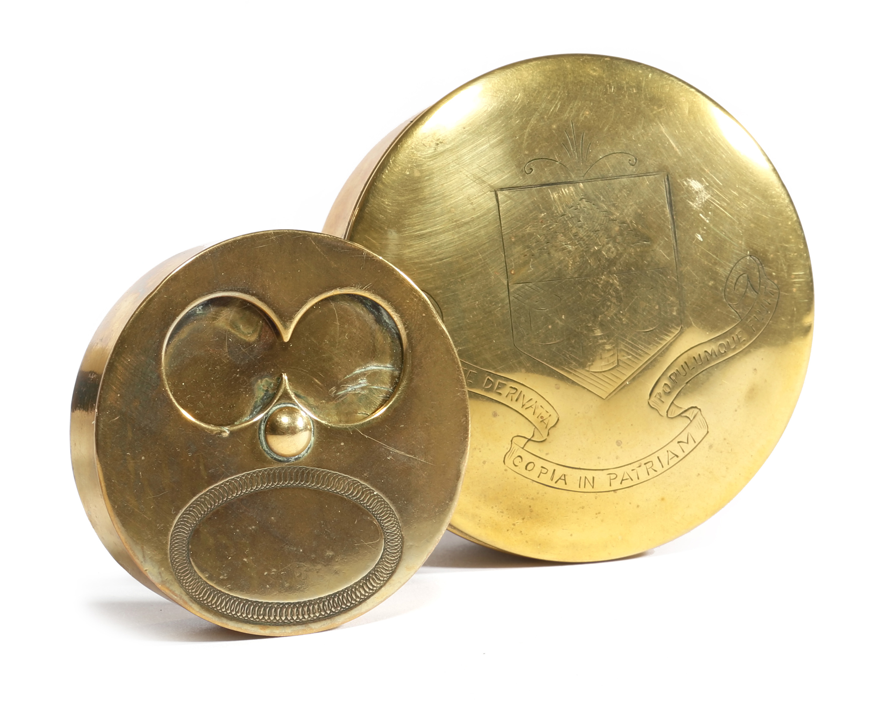 A 19TH CENTURY BRASS CIRCULAR SNUFF BOX the pull-off lid engraved with the coat of arms of the