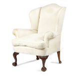 A WALNUT AND BEECH WING ARMCHAIR IN GEORGE II STYLE LATE 19TH CENTURY with scroll arms, on leaf
