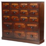 A BANK OF MAHOGANY APOTHECARY DRAWERS 19TH CENTURY BUT LATER ADAPTED with eighteen labelled drawers,