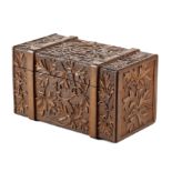 A BLACK FOREST LINDEN WOOD BOX IN THE FORM OF A TRUNK LATE 19TH CENTURY relief carved with scrolling