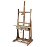 A PINE ARTIST'S EASEL EARLY 20TH CENTURY paint splattered, the adjustable rest fitted with two