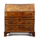 A GEORGE II WALNUT BUREAU C.1730-40 with cross and feather banding, the hinged fall revealing an