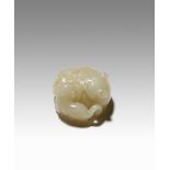 A CHINESE YELLOW JADE CARVING OF TWO CATS 18TH CENTURY The mother cat lies curled up with her head